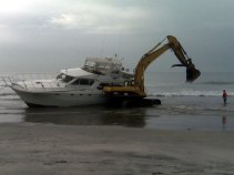 Damaged Yacht Towed Ashore