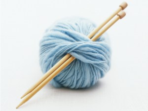 Knitting needles in ball of yarn