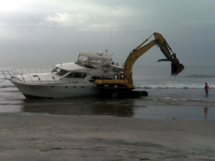 Damaged Yacht Towed Ashore