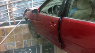 Car Suspended Over Building