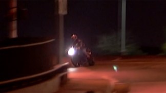 RAW: Cop Jumps to Stop Moving Motorcyclist
