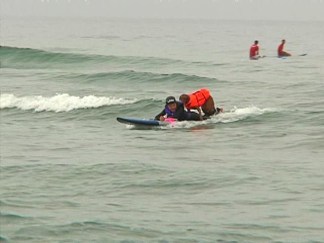 Dog Tandem Surfs with Adaptive Surfer