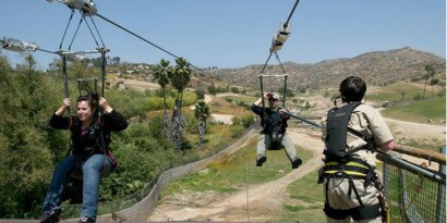 Tonya Castillon and Lance Beahm make their way into the landing area after their ride on the 3,677-foot-long Flightline that passes over the Asian and African animal exhibits at the San Diego Zoo's Wi Tonya Castillon and Lance Beahm make their way into the landing area after their ride on the 3,677-foot-long Flightline that passes over the Asian and African animal exhibits at the San Diego Zoo's Wi