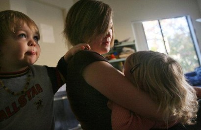 Kelli Roman breast-feeds her 22-month-old daughter Ivy with her 3-year-old son Abe at her side at her Fallbrook apartment. 