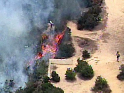 Rangers were seen using a hose and fire extinguisher to stop the flames before firefighters arrived. Rangers were seen using a hose and fire extinguisher to stop the flames before firefighters arrived.