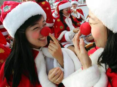 Girls in Santa suits with red noses Girls in Santa suits with red noses
