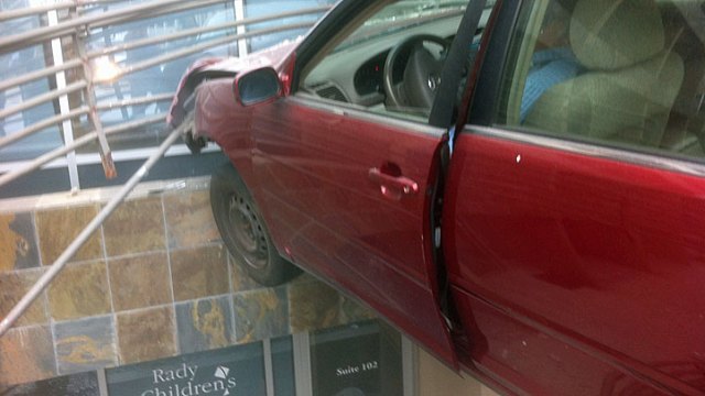 Car Suspended Over Building