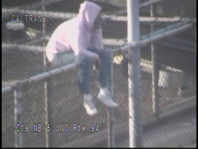 Woman Plays Balancing Act Above I-5