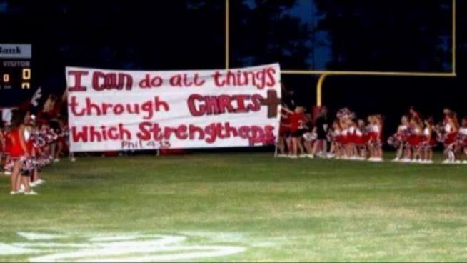 A Texas public high school cheerleading squad can keep emblazoning Bible verses on banners to cheer on football players at games, at least for now, a judge ruled Thursday. The school district had barred the cheerleaders from using the slogans on their banners after a Wisconsin atheist group complained, saying they violated First Amendment rights, but the Texas court issued a temporary injunction on Thursday to prevent that ban from going into effect before trial comes in June. The Kountze High School cheerleaders had gotten the support of the Texas Attorney General in their battle over the banners, which they argued were the result of a student-led initiative and therefore didn't violate others' right to freedom from religion. A lawyer for the school, however, said that although the banners were an innocent idea, they represented the school and thus had to be considered government speech.