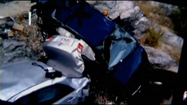 A man rescued six days after his car went off a cliff in the Angeles National Forest is hospitalized with numerous fractures. A second man found dead at the scene in another car is identified.