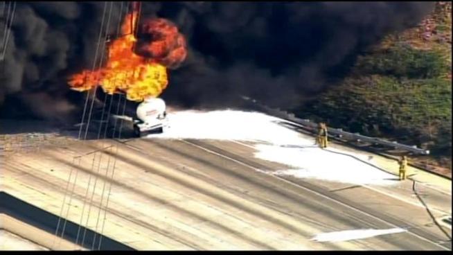 Crews respond to a tanker fire that sent a thick column of smoke above the 60 Freeway.
