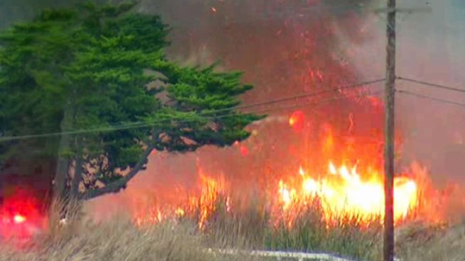 The fire burned grass and brush in the lagoon producing smoke that was visible from Interstate 5.