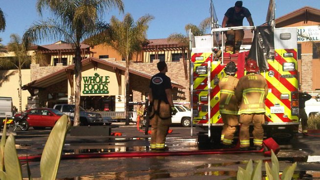 NBC 7 reporter Brandi Powell talks to customers outside a store that was evacuated for a gas leak.