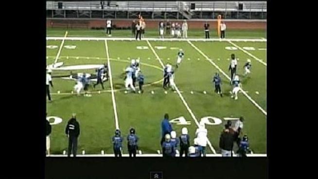 The San Diego youth football coach arrested for assaulting a rival coach after a game Saturday has been suspended indefinitely and faces a lifetime ban according to a league spokesperson.