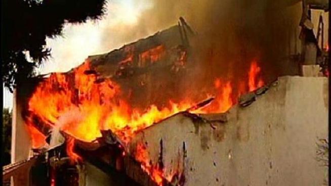 A mother of eight children, whose house was devoured by flames Tuesday, credits her husband for saving her and three of their children who were home at the time.