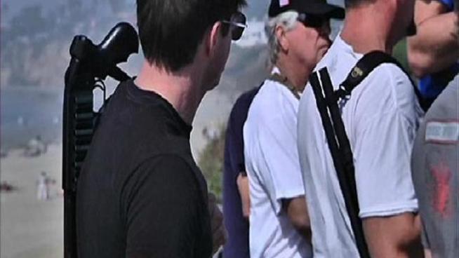 Nearly 30 people carrying shotguns, rifles and pistols gathered at Pacific Beach in a demonstration supporting open carry of firearms on Saturday.
