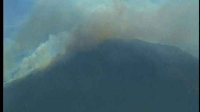 The fire, reported on the Mexico side of the international border, sent ash and smoke into the air in some sections of San Diego County.