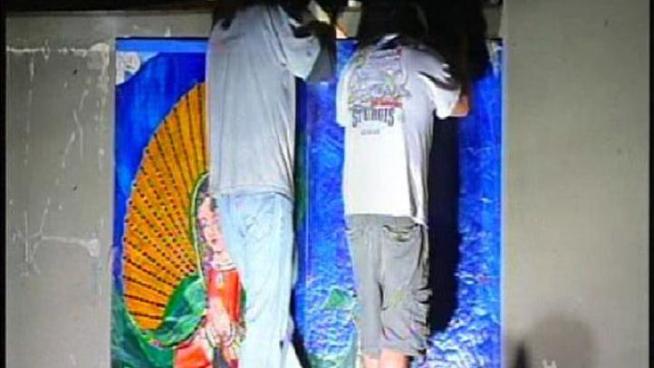 Using hammers and plastic wrap, a team of four workers carefully removed the so-called Surfing Madonna mosaic during the night on June 22, 2011.