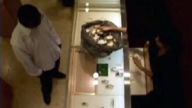 Surveillance video taken inside a jewelry store in the Fashion Valley Mall shows an armed man calmly walking in, quietly demanding a bag of Rolex watches and then calmly walking out of the store.