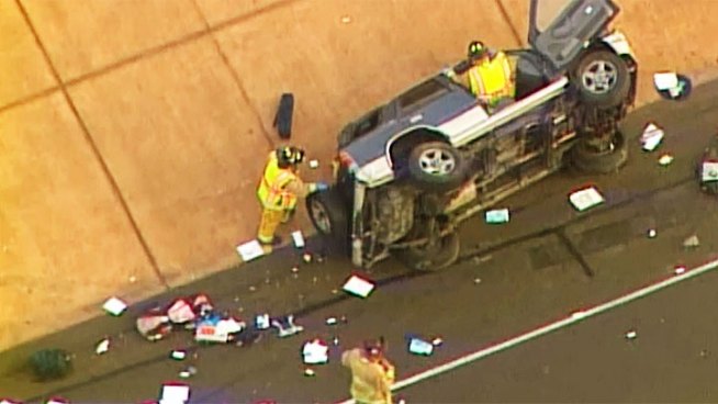 Firefighters pulled two people from an overturned vehicle on the Mission Gorge on ramp to westbound I-8.