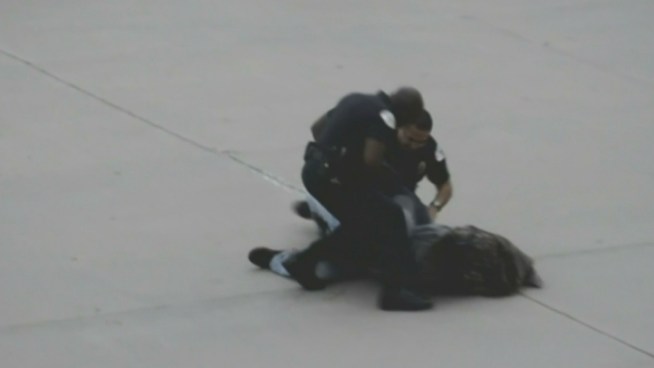 Video has emerged of two officers punching a suspect in the head and torso during a rally Sunday.