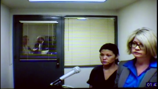 At a hearing on Friday evidence presented suggested that a woman allegedly tried to push her mother into a burning room and bind her to a table when she tried to get away.