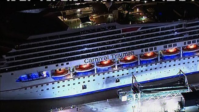 The crippled Carnival Triumph was cheered into port Thursday night after five days adrift in the Gulf of Mexico without power and with rapidly deteriorating conditions.