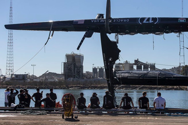 Crews on Wednesday towed ashore a nearly $8 million, 72-foot catamaran used by the Oracle Team USA, the defending America's Cup champion, out of the San Francisco Bay, after it had capsized the day before.