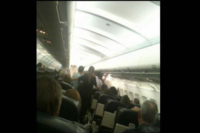 Passengers said they had to tackle a man who was behaving aggressively and grabbing women during a flight from Chicago to Orange County's John Wayne Airport Tuesday night. Robert Kovacik reports for the NBC4 News at 11 p.m. on Sept. 26, 2012.