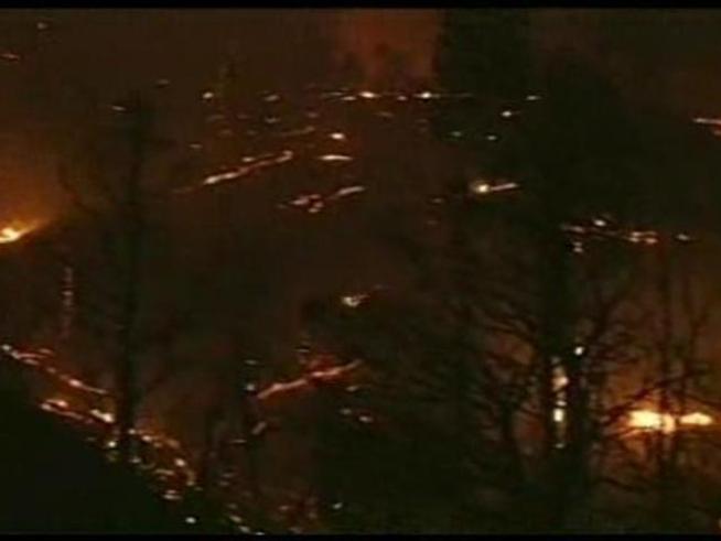 The blaze scorches thousands of acres and burns homes.