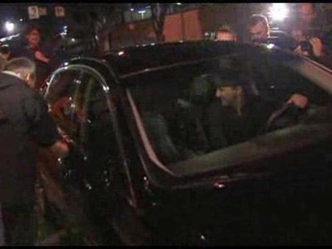 The former Bell city manager hustles to his car after his release from jail.