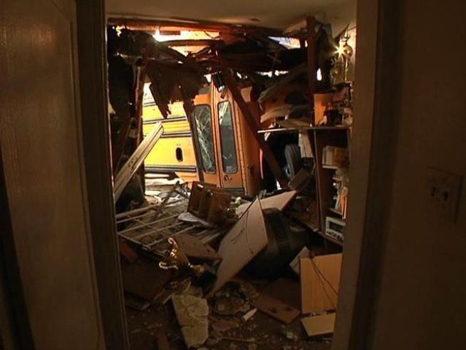 A driver making a left turn crashed into a van and then a home in Lincoln Park.