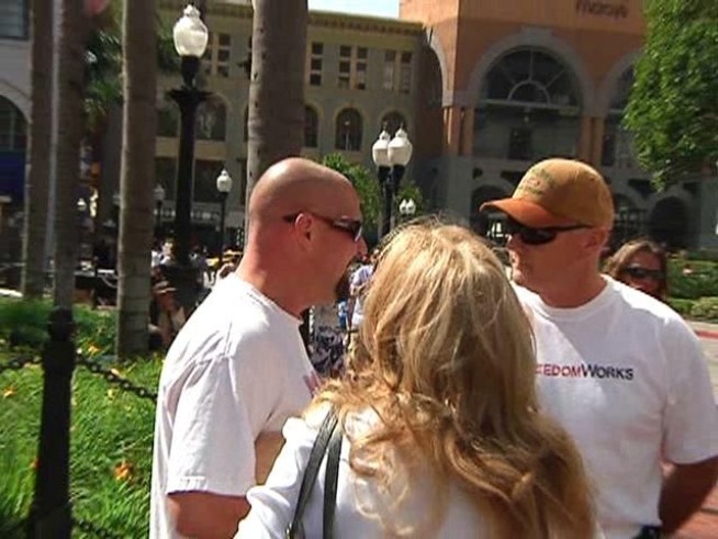 A passerby got into a heated debate with protestors who are against health care reform legislation.