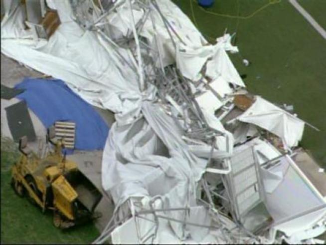 Federal inspectors sift through the debris of the collapsed canopy of the <a title=