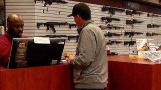 A man looks at firearms at the Poway Weapons & Gear Range in San Diego's North County.