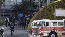 Law enforcement officials walk toward YouTube offices in San Bruno, Calif., Tuesday, April 3, 2018.