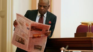 State Sen. Steven Bradford looks at newspaper