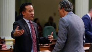 Assemblyman David Chiu, D-San Francisco, left, speaks with Assemblyman Rob Bonta, D-Alameda, during the Assembly session in Sacramento, California, Jan. 9, 2020. Chiu has introduced a bill to eliminate the mortgage interest deduction on vacation homes and use the money to pay for homeless services. The bill would also lower the amount of mortgage interest people could claim for their primary homes on their state taxes.