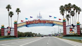 The road to the entrance of Walt Disney World has few cars Monday, March 16, 2020, in Lake Buena Vista, Fla.