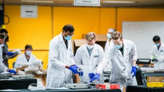 Staff work in a ventilator refurbishing assembly line at Bloom Energy in Sunnyvale, Calif. on Saturday, March 28, 2020.