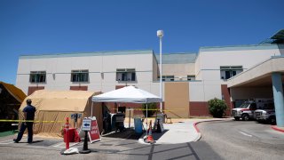 A tent sits in front of the El Centro Regional Medical Center to help process patients with symptoms related to the new coronavirus Wednesday, May 20, 2020, in El Centro, Calif.