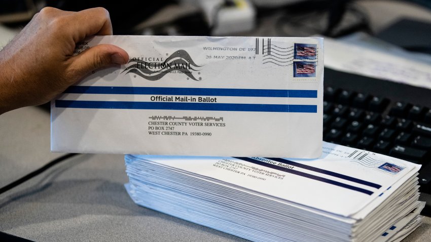 In this May 28, 2020, file photo, Dave Turnier processes mail-in ballots at at the Chester County Voter Services office in West Chester, Pennsylvania, prior to the primary election.