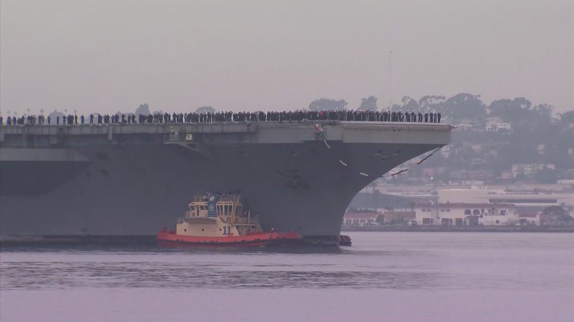 San Diegans await the return of their loved ones return from a 10-month &#8220;around the world&#8221; deployment. Family members held &#8220;welcome home signs&#8221; as upbeat music played in the background while USS Lincoln cruised into its new homeport of San Diego.