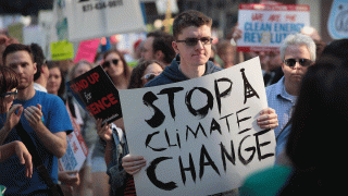 In this June 2, 2017, file photo, demonstrators protest President Donald Trump’s decision to exit the Paris climate change accord in Chicago.