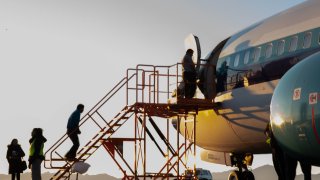 Deportees boarding a plane to return them back to Mexico