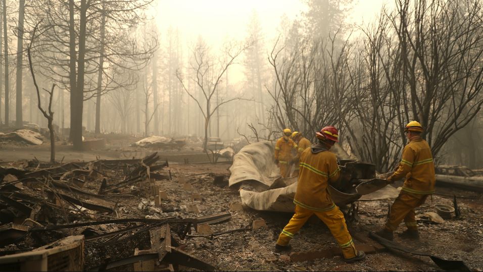 San Francisco firefighters dismantle a burned mobile home as they search for human remains at a mobile home park that was destroyed by the Camp Fire on November 14, 2018 in Paradise, California. (Photo by Justin Sullivan/Getty Images)
