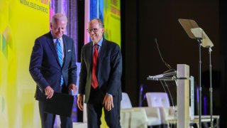 Former U.S. Vice President Joe Biden, a 2020 Democratic presidential candidate, and Tom Perez, chairman of the Democratic National Committee (DNC), exit the stage during the DNC Women's Leadership Forum conference in Washington, D.C., U.S., on Thursday, Oct. 17, 2019.