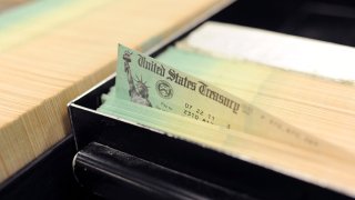 In this photo illustration U.S. Treasury checks are piled at the U.S. Treasury printing facility July 18, 2011 in Philadelphia, Pennsylvania.