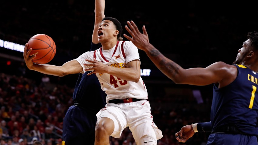 Rasir Bolton of the Iowa State Cyclones lays up a shot as Derek Culver of the West Virginia Mountaineers blocks in the first half of the play at Hilton Coliseum on March 3, 2020 in Ames, Iowa.