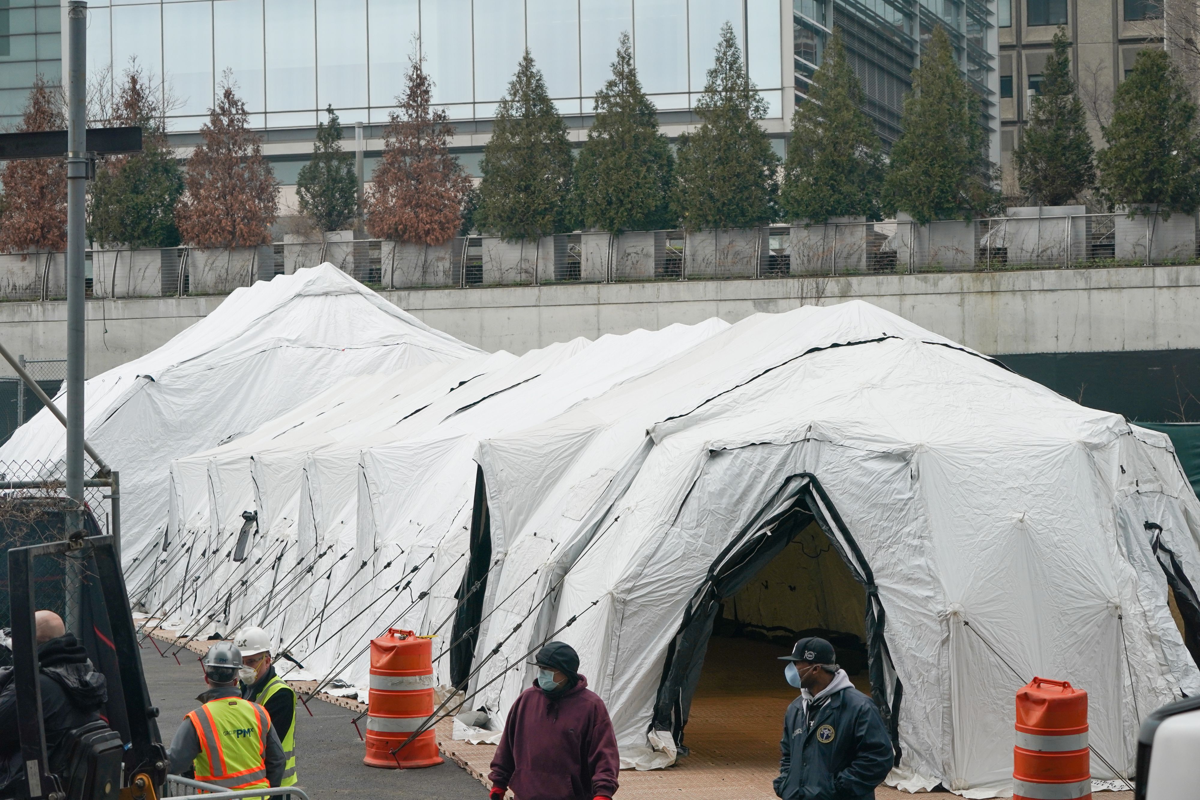 Workers build a makeshift morgue outside of Bellevue Hospital to handle an expected surge in Coronavirus victims on March 25, 2020 in New York. – President Donald Trump declared the beginning of the end of the coronavirus crisis in the United States on Tuesday and called for a quick end to social distancing, even as New York’s governor compared the growing pandemic to a “bullet train.” (Photo by Bryan R. Smith / AFP) (Photo by BRYAN R. SMITH/AFP via Getty Images)